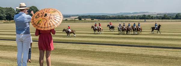 People riding horses on a fieldAI-generated content may be incorrect.
